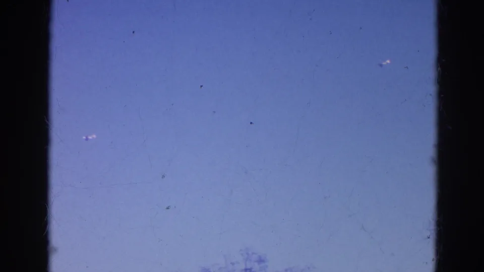 Final 1968 Wauconda frame showing mostly blue sky, faint treetops, and visible 8mm film edges.