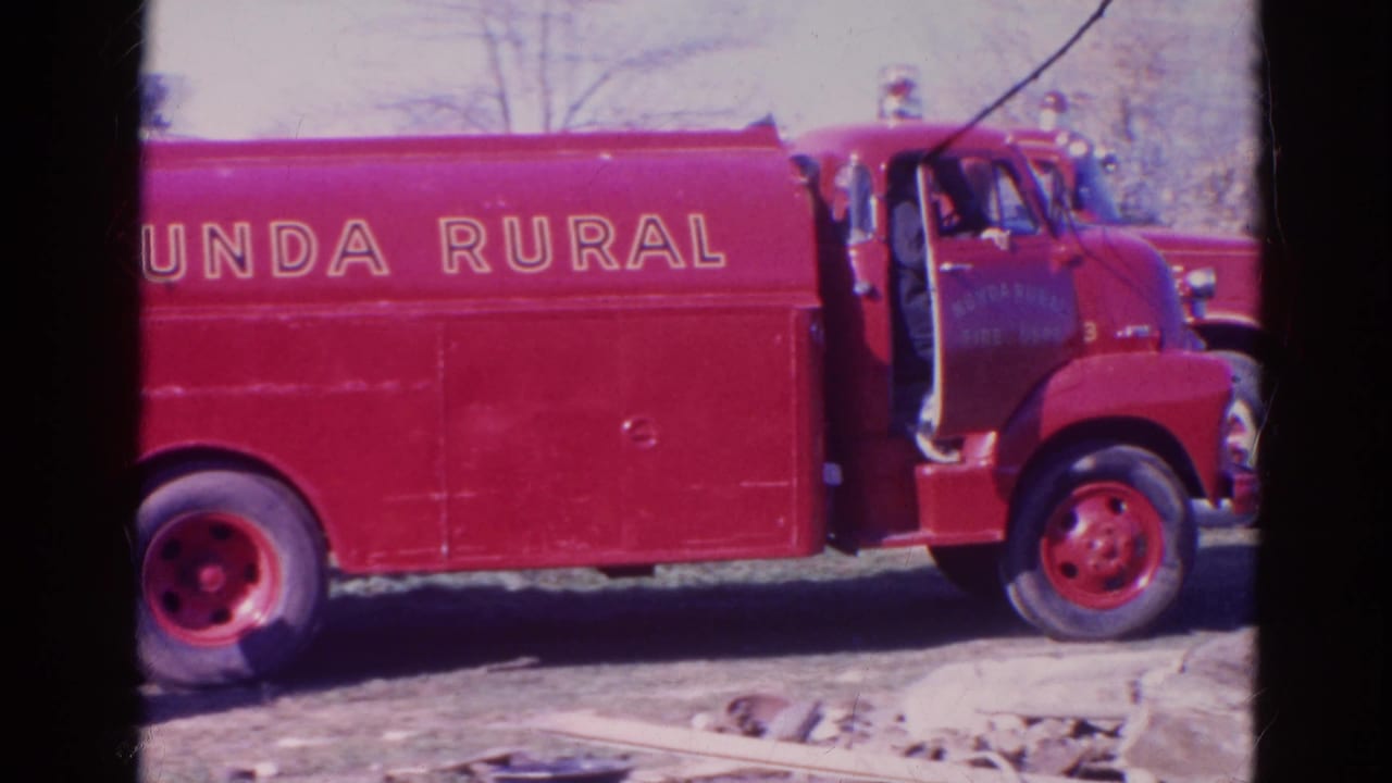 Red Nunda Rural fire truck parked outdoors with an open cab door.