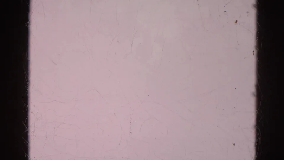 The final 8mm frame is largely overexposed and pale, showing scratches, dust marks, and dark film edges with no clear subject.