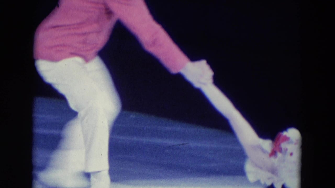 Chicago 1969 8mm frame showing costumed ice performers on a dark rink with a small cat-like puppet or figure near the ice.