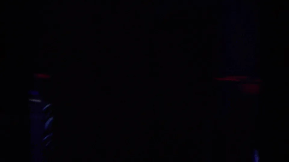 Dark closing 8mm frame from the Chicago 1969 ice performance, with only faint rink lighting visible.
