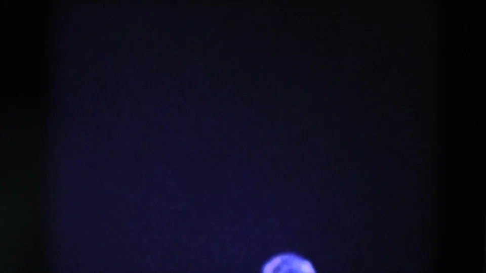 Low-light 1969 Chicago concert frame with a dark stage field and a partial head at the bottom edge.