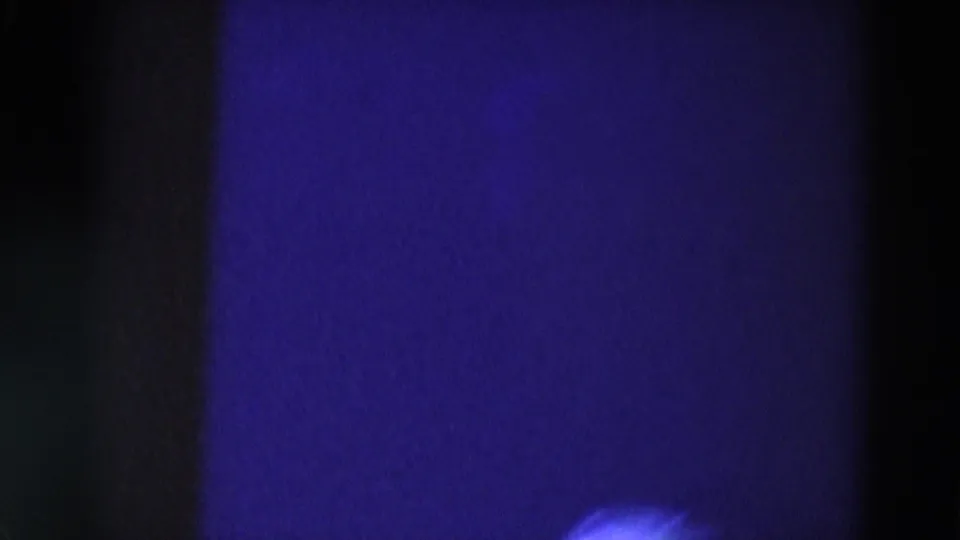 Low-light 1969 Chicago concert frame with blue stage lighting and a blurred bright figure or garment near the bottom.