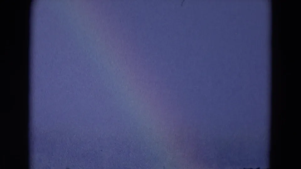 Blue-gray 8mm frame with very limited detail, likely an exposure or transition moment within the short 1969 home-movie clip.