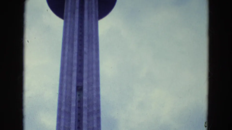 1969 home-movie frame with the tower shaft passing through a circular observation deck.
