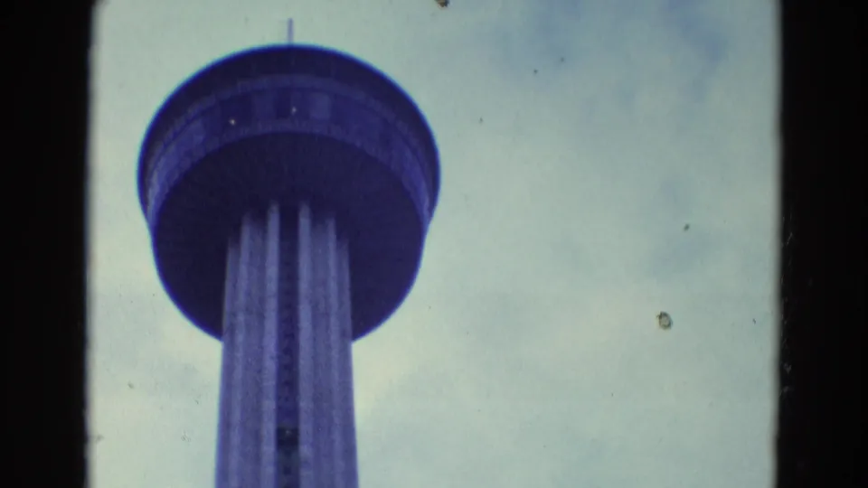 1969 Diller, Nebraska home-movie frame with the tower's circular deck higher in view as the camera pans upward.