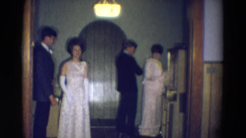 In the final frame, the bride stands centered while suited men and women with flowers arrange themselves in the private 1969 Diller wedding interior.
