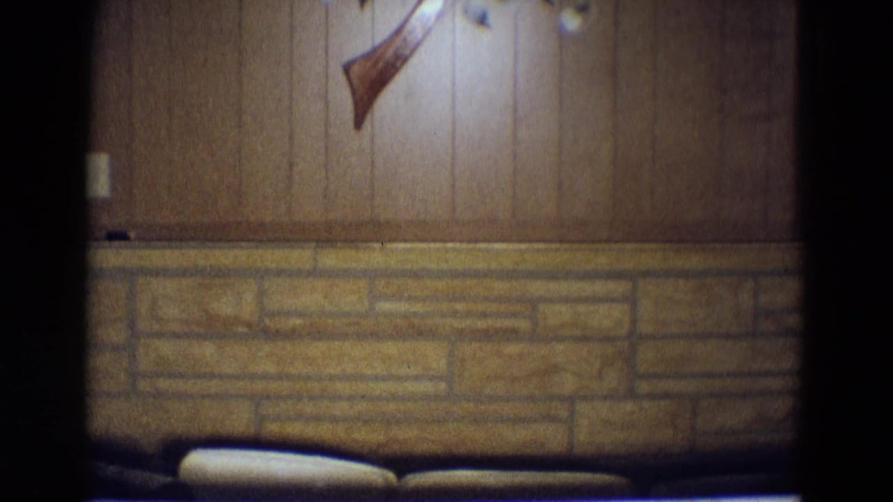 Paneled wall and stone wainscot above dark seating or counter edge.