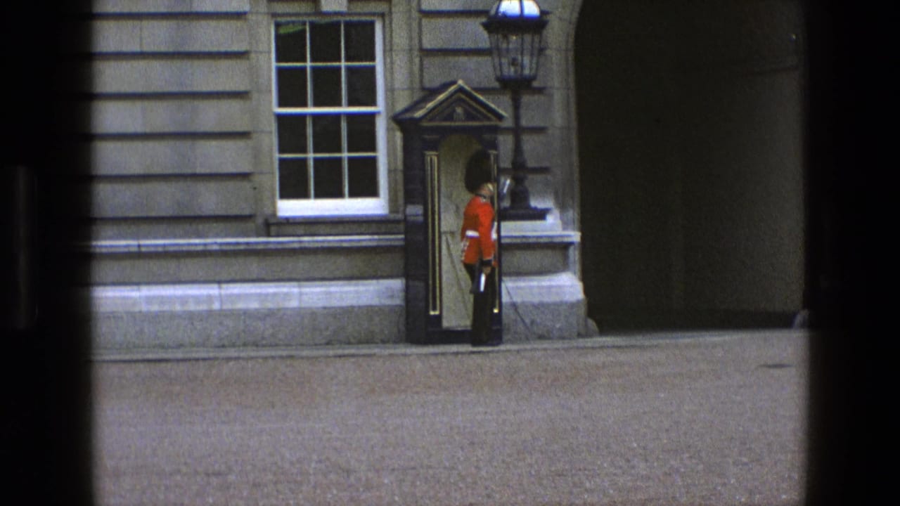 Royal guard standing beside a sentry box outside a stone building.