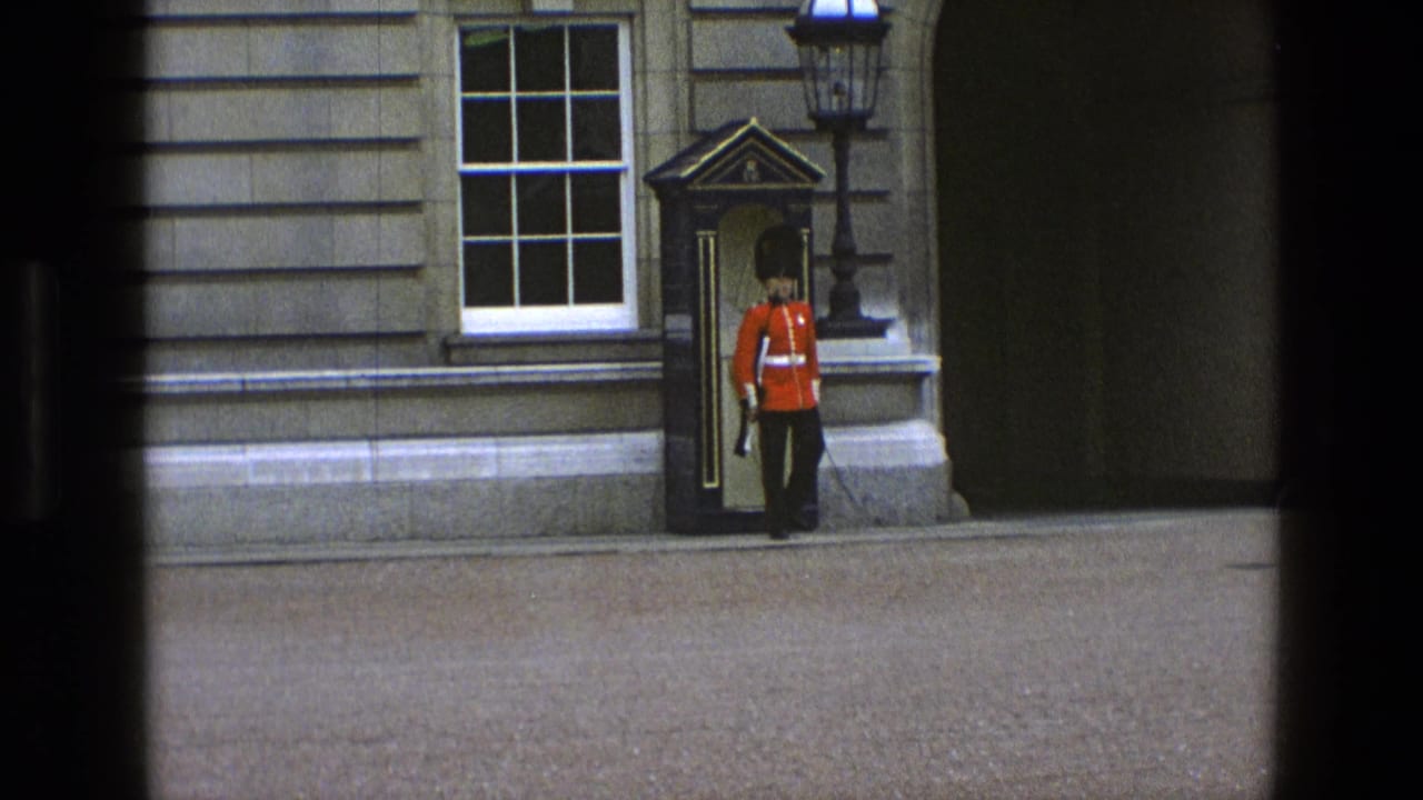 1969 England frame with a royal guard at attention in a sentry box setting outside a stone building.