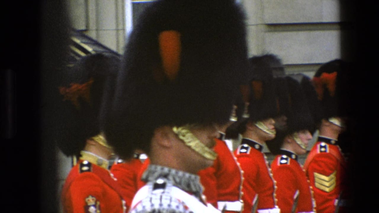 Uniformed guards in red tunics stand in a row, with one large foreground hat obscuring part of the view.