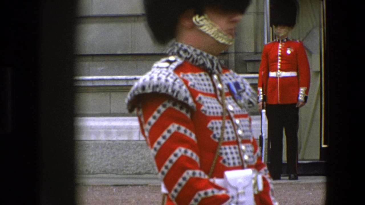 Close foreground view of a ceremonial guard with another guard standing by a doorway behind him.