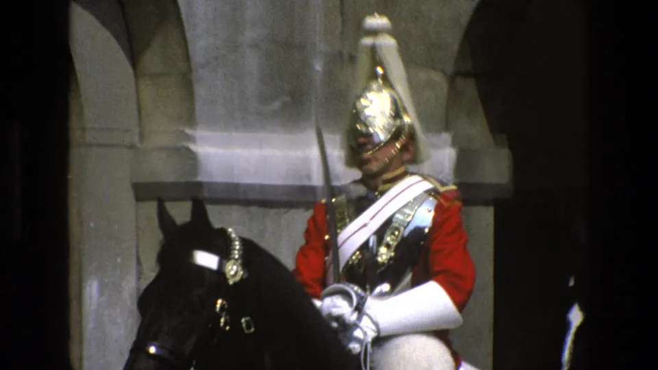 1969 England frame showing the mounted ceremonial guard turned slightly, with the black horse close in the foreground.