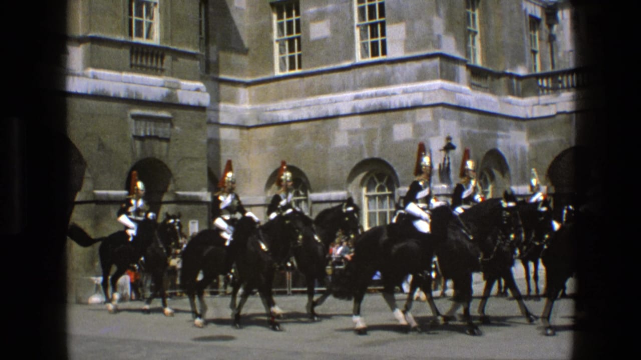 Armored mounted guards ride black horses through a stone courtyard.