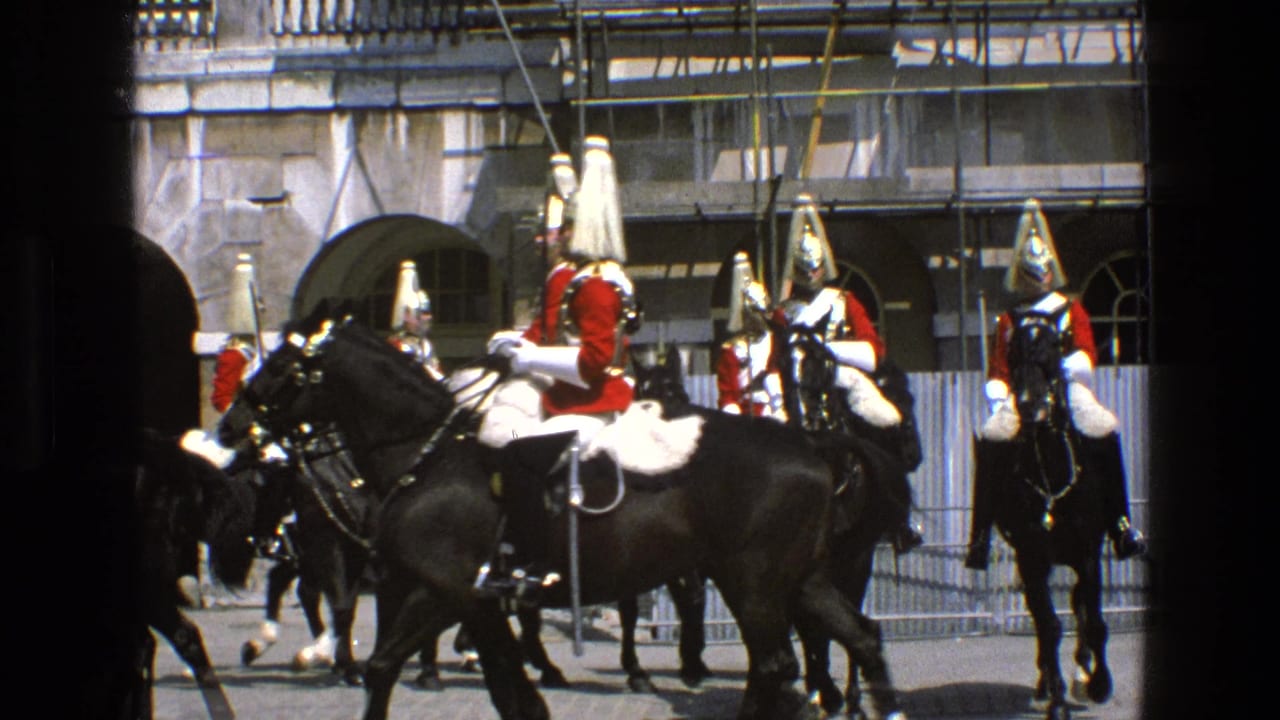 Mounted British ceremonial guards appear in formation beside arched stone doorways in 1969 England home-movie footage.