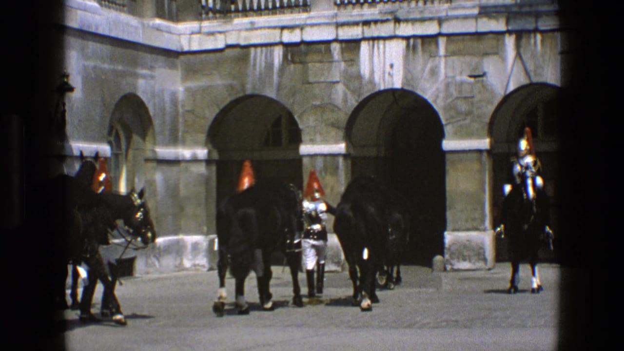 Guards and horses move near arched openings in a stone courtyard.