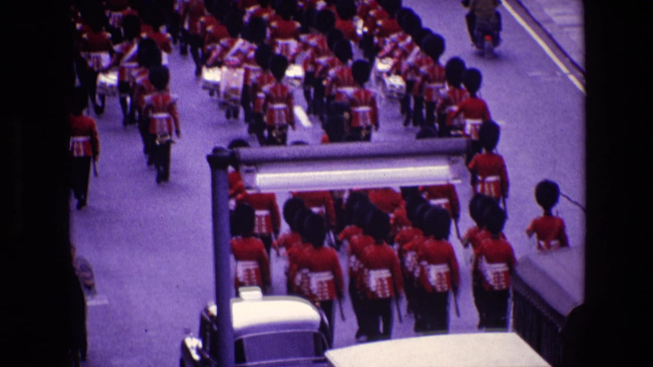 Marching band continues down the road with a mounted officer and vehicles visible.