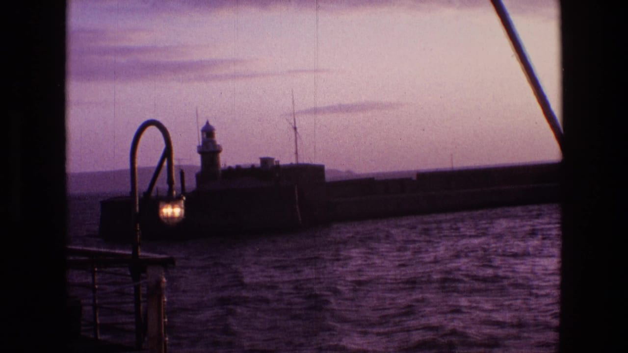Harbor water with a lighthouse on a breakwater and a glowing curved lamp in the foreground.
