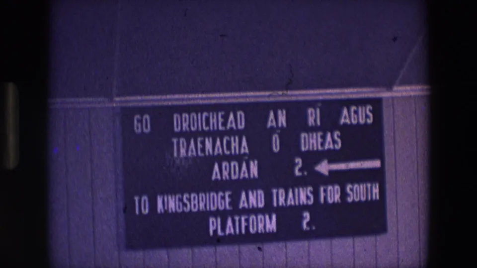 Soft 8mm frame of an Irish station wayfinding sign with English and Irish text for Kingsbridge and trains for the south.