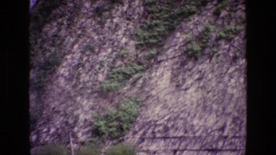 1969 Ireland home-movie frame showing the upper sod or thatch roof surface with scattered moss and plant growth.