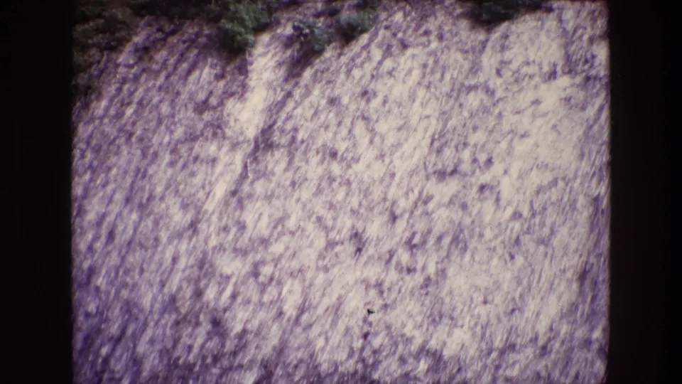 1969 Ireland 8mm still showing a textured pale hillside surface with limited green growth at the upper edge.
