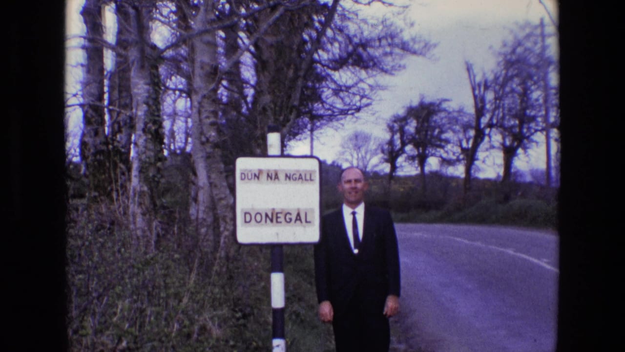 Man smiles near the Donegal sign with a curving road behind him.