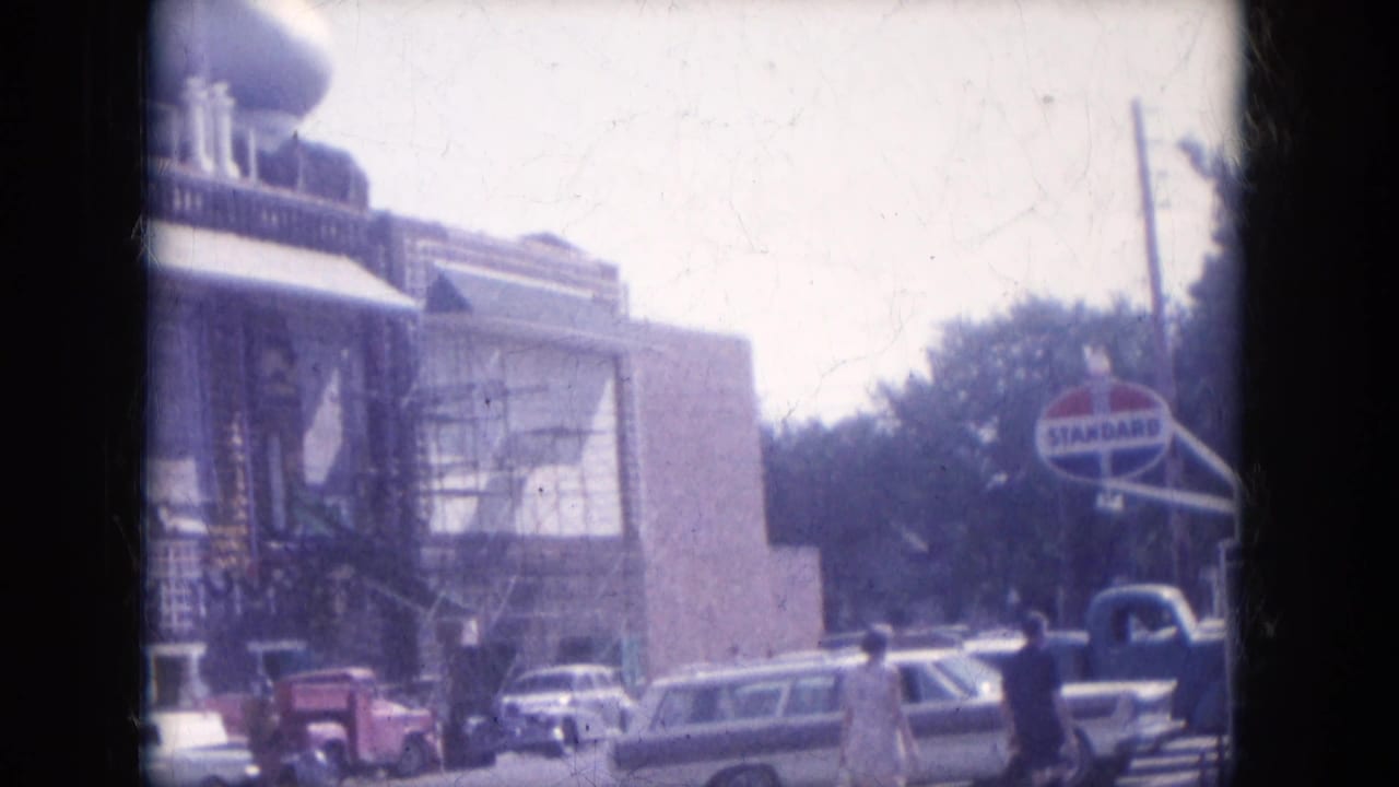 1969 Lake Canyon street view with a domed roadside building, parked cars, pedestrians, and a visible Standard Oil sign.