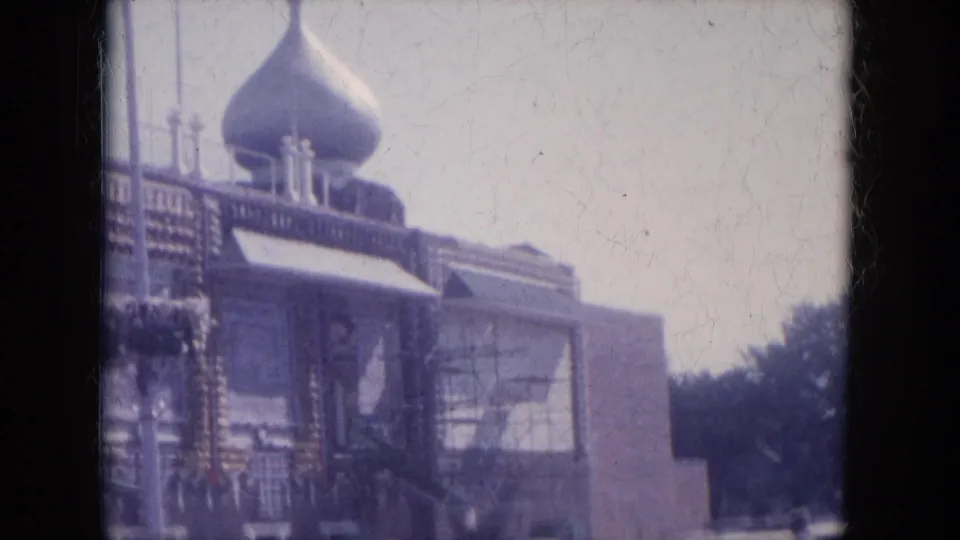 1969 Lake Canyon view of a domed building facade with decorative trim, street poles, and trees at the edge of frame.
