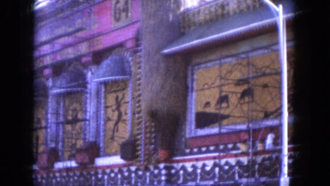 1969 Lake Canyon, Arizona footage frames the ornate building exterior with painted panels, arched architectural details, and a streetlight.