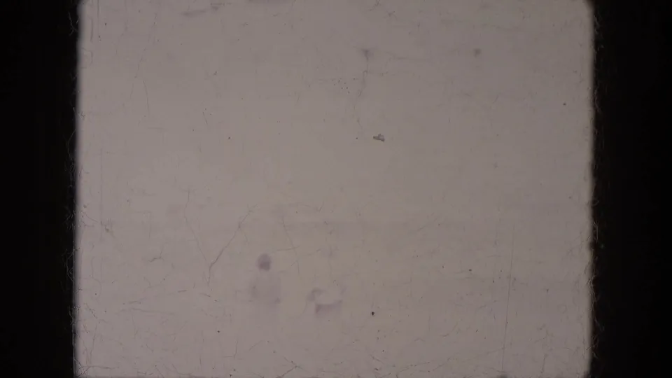 Soft, scratched 8mm frame from Lake Canyon, Arizona, with a faint person crossing the open area.