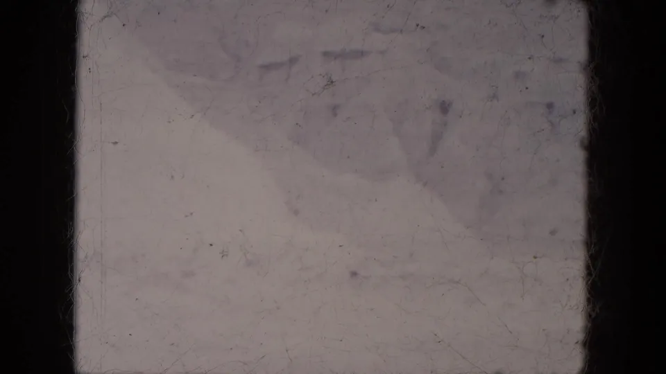 1969 Lake Canyon, Arizona frame with a pale snow-covered view, faint distant shapes, dark gate edges, and visible 8mm abrasion.