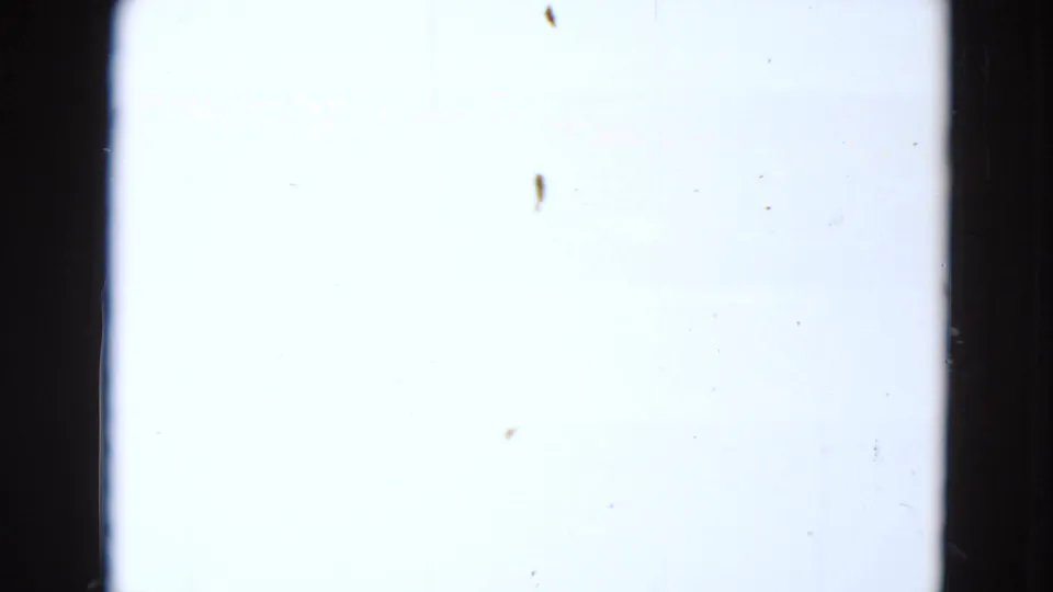 Overexposed 8mm frame from the 1969 Minnesota boating clip, showing pale film area with dust and edge marks.
