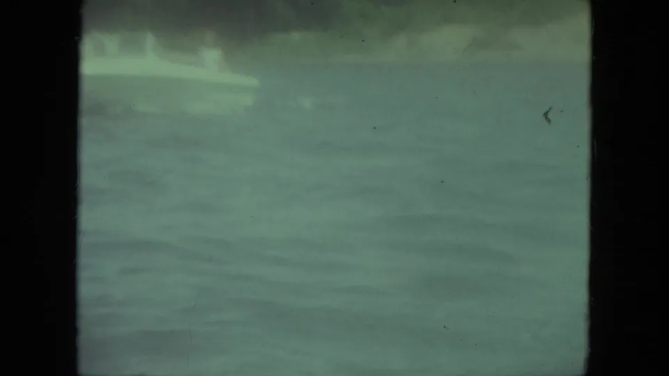 A 1971 Mississippi lake view shows rippled water and a faint shoreline, with the boat no longer clearly visible in the frame.