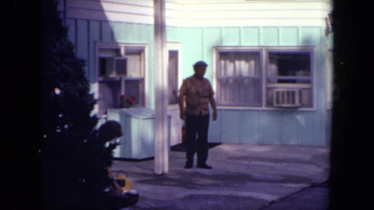The man remains outside the Mississippi motel room, framed by pale siding, curtains, and a window air conditioner.