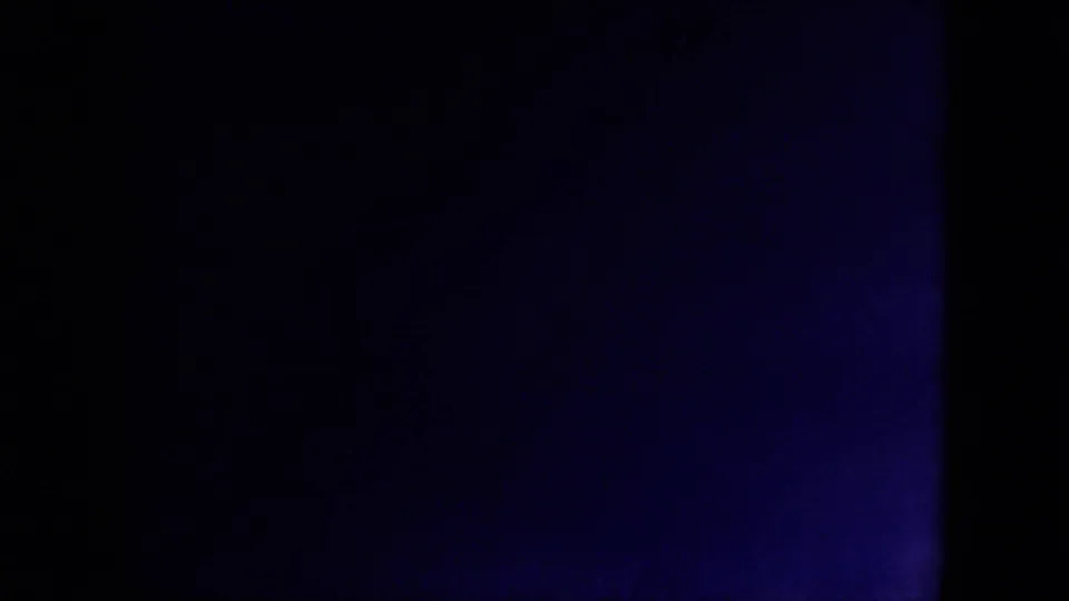Underexposed blue 8mm frame from the 1971 Mississippi clip, with heavy darkness and faint film texture.