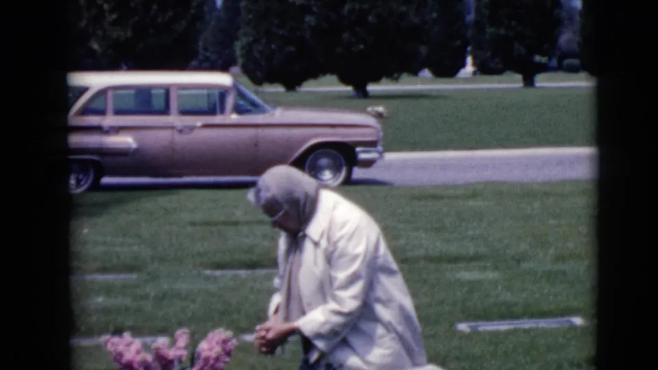 The 1968 Clarksdale cemetery view shows a headscarved woman kneeling by flowers, with grass, grave markers, and a pink station wagon behind her.