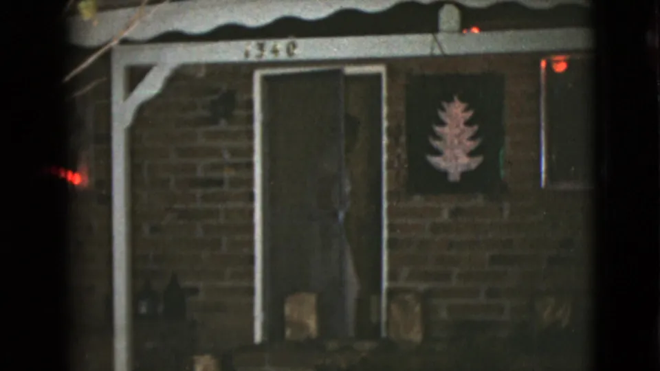 The doorway of the Clarksdale house is mostly closed, with one figure dimly visible behind the door in the 1968 night scene.