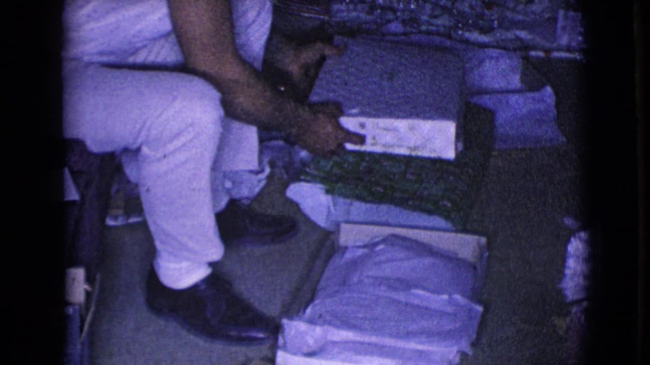 Young man holds a partially opened rectangular gift box.