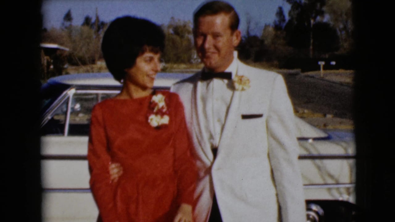 The newlywed couple stands arm in arm beside a white car in the 1968 Clarksdale, Arizona home-movie footage.