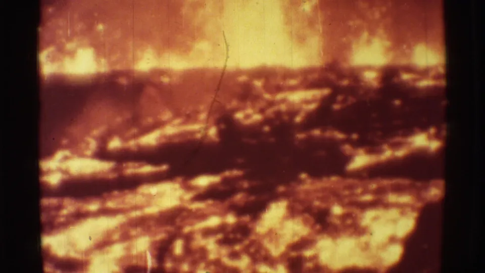 Mauna Ulu lava activity appears as a bright orange glow behind dark, uneven volcanic crust in this 1971 8mm frame.