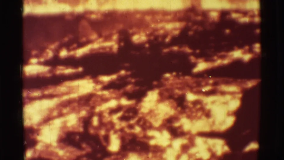 1971 Mauna Ulu footage shows dark volcanic crust crossing bright molten patches, softened by grain and exposure bloom.