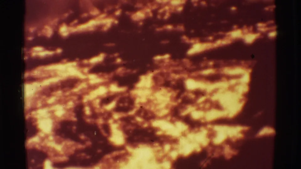 Close 1971 Mauna Ulu 8mm view of molten lava glowing orange beneath darker crusted rock textures.