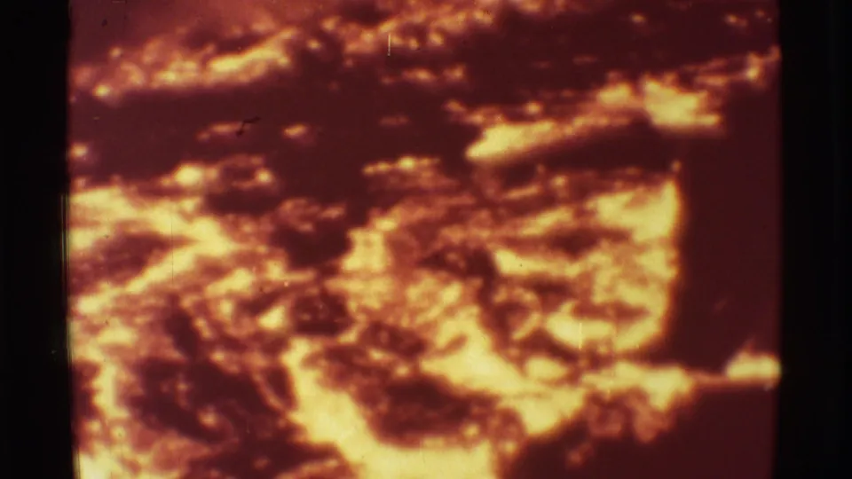 Close 8mm Mauna Ulu lava view with glowing orange molten areas and darker crusted formations.