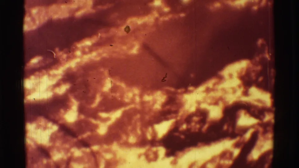 1971 Mauna Ulu close-up with a curved bright lava edge and darker cooling surface on 8mm film.