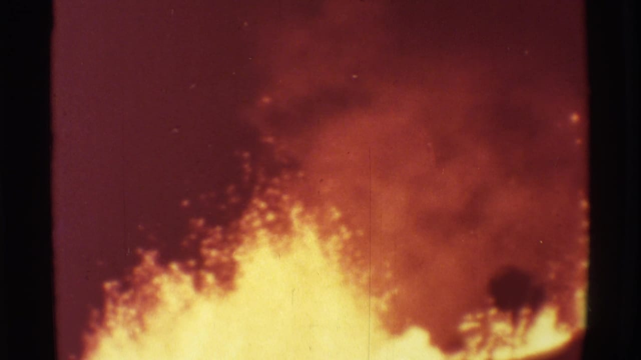 Bright lava boils upward against red smoke and dark frame edges.