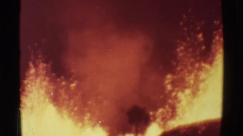 Mauna Ulu lava activity in 1971, with red smoke, yellow molten glow, and visible 8mm film texture.