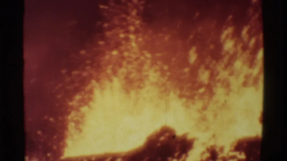 1971 Mauna Ulu 8mm frame with glowing lava spray, dark rock silhouettes, and visible vintage film wear.