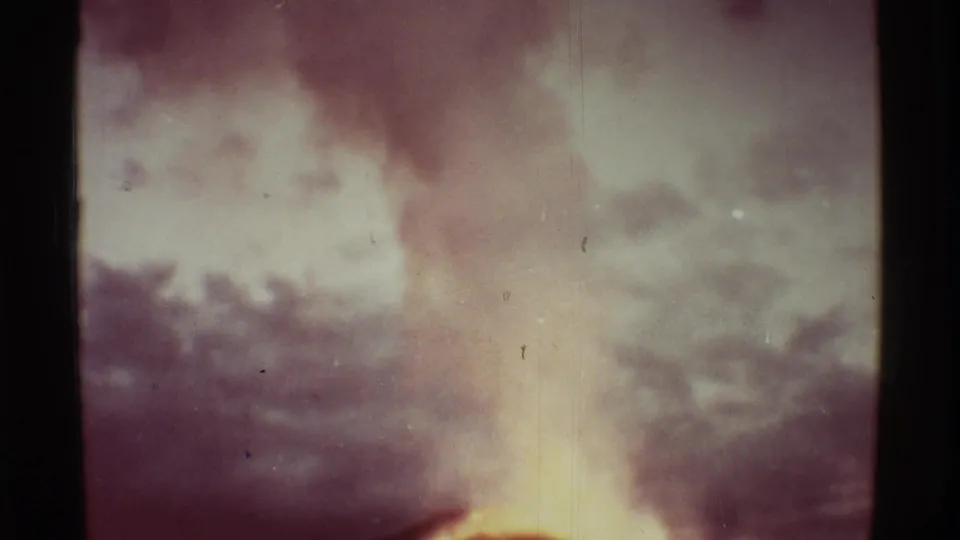 1971 Mauna Ulu 8mm frame showing a pale plume rising from glowing lava or volcanic activity below.