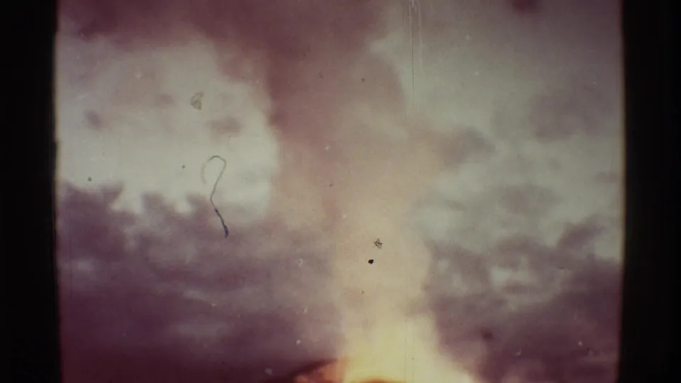 1971 Mauna Ulu 8mm frame with a diffuse smoke or ash plume rising above a bright volcanic glow.