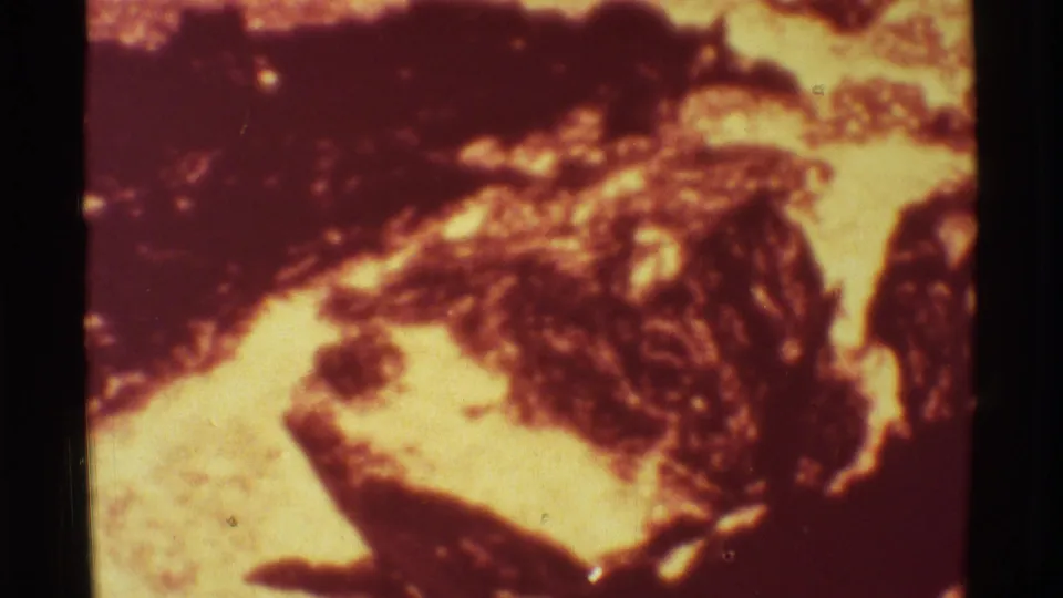 1971 Mauna Ulu 8mm frame showing turbulent molten lava texture and high-contrast volcanic surfaces.